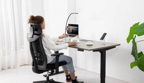 Customer testimonial photo: happy designer working at their new ergonomic workstation