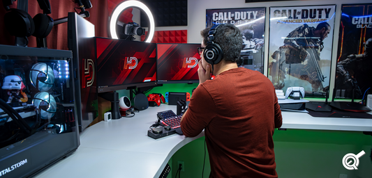 Photo of gaming gear, mouse, keyboard, joystick, headset on black table background.