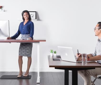 Designer working at a height-adjustable standing desk, demonstrating flexibility and comfort